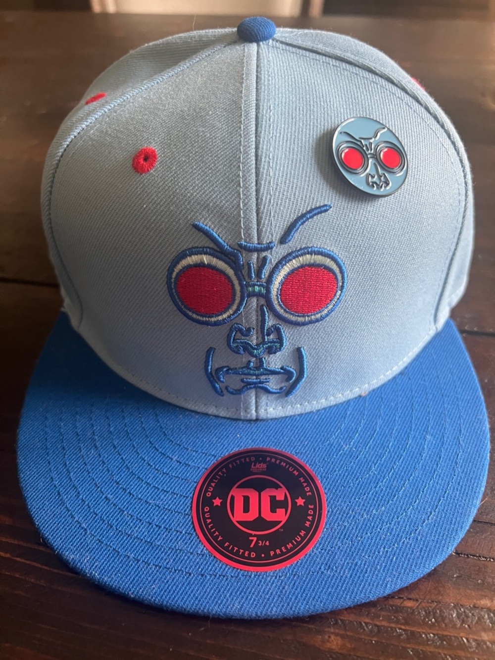 DC Light blue and Fitted Hat with Red Accents. Has the collector Pin 7 3/4